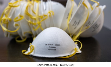 A Safety N95 Surgical Mask Sits In Front Of A Pile Of Masks During The Quarantine Of 2020