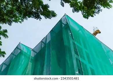 Safety net covering the building for the construction of high-rise buildings in the community - Powered by Shutterstock