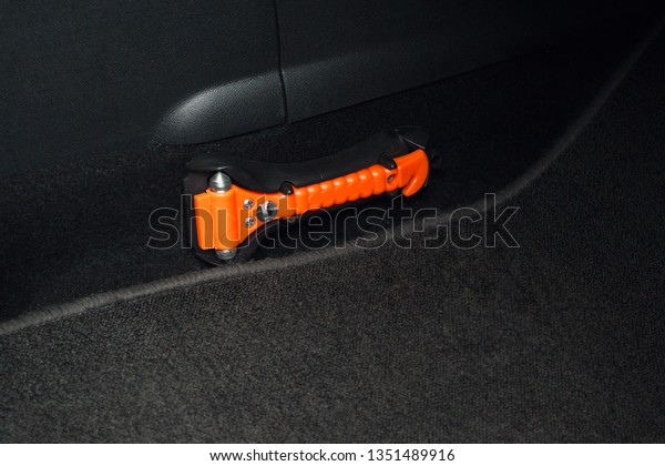 Safety orange hammer in a car\
\
