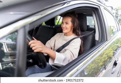 Safety And People Concept - Happy Smiling Young Woman Or Female Driver Driving Car In City