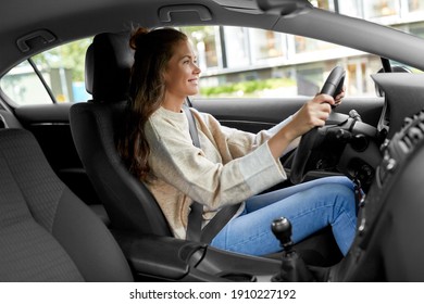 Safety And People Concept - Happy Smiling Young Woman Or Female Driver Driving Car In City