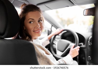 Safety And People Concept - Happy Smiling Young Woman Or Female Driver Driving Car In City