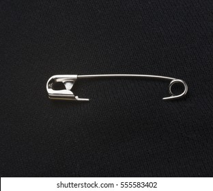 Safety Pin On Black Fabric