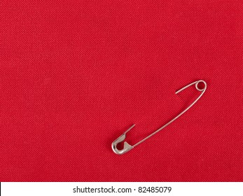 Safety Pin In Red Fabric Swatch For Background