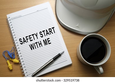 Safety quotes/slogan written on notebook, promoting good safety practices at workplace - business conceptual.