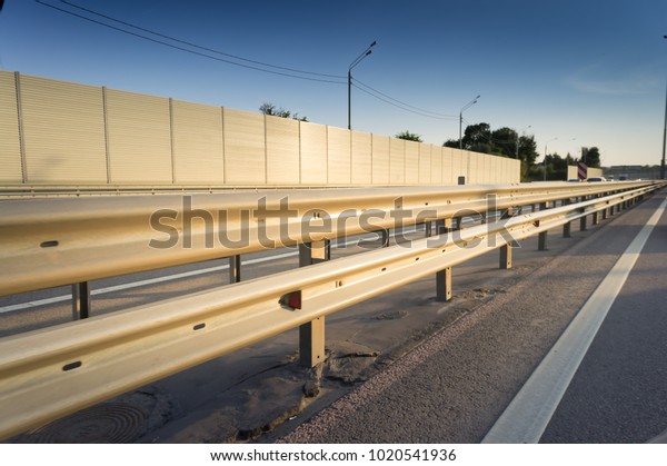 Safety rail on\
freeway with accoustic\
barrier