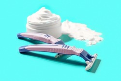 Safety Razors And Shaving Foam On Color Background
