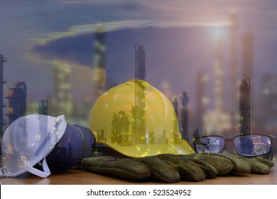 Safety in Refinery Concept ,Double exposure of safety standard set  on working table, Background power plant , heavy petrochemical industry estate use for energy , power , fuel ,gas .