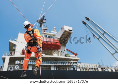 Safety rope access Demonstration, People worker sprinkle during ship repair in shipyard accommodation bridge deck background.
