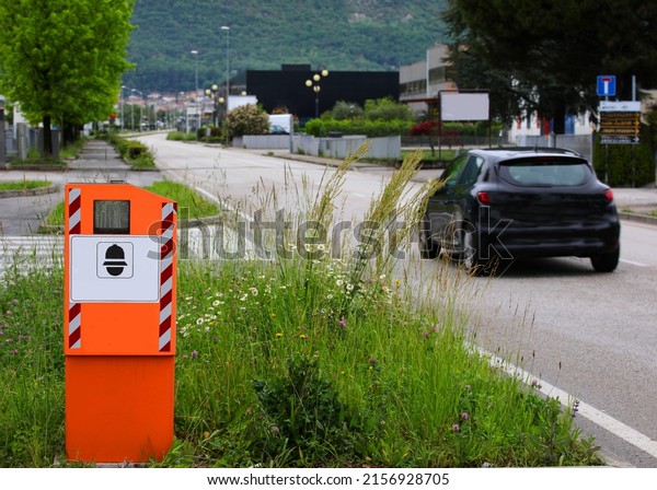 Safety Speed Cam\
and a black car on the\
road