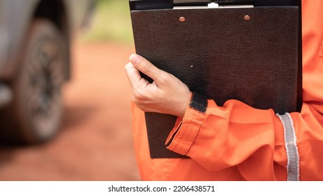 A Safety Supervisor Or Manager Is Holding Paper Clipboard During Perform Safety Audit In Construction Site. Industrial Safety Working Action Scene, Close-up And Selective Focus.