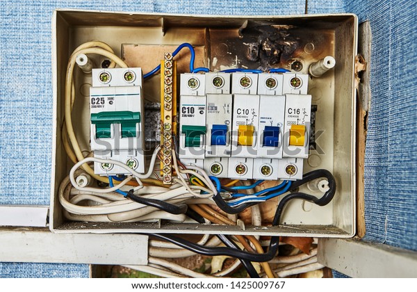 Safety switch\
problems, old burned electrical switchboard and circuit breakers\
located in residential\
building.