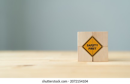 Safety symbols and first signs, work safety, caution work hazards, danger surveillance, zero accident concept on wooden cubes with beautiful  grey background and copy space. Safety banner. - Shutterstock ID 2072154104