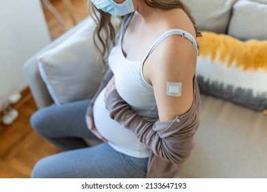 Safety Vaccination During Pregnancy Cocnept. Cheerful Pregnant Young Woman Got Vaccinated Against COVID-19, Showing Her Arm With Band On And Hugging Her Big Tummy, Expecting Baby, Copy Space