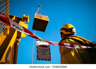 Safety Work Practice Red And White Warning Danger Tag Tape Sign Applying On At Working Area Exclusion Dropped Object During Rigger Operating Positive Comm Lifting Heavy Load In Crane Lifting Cage  