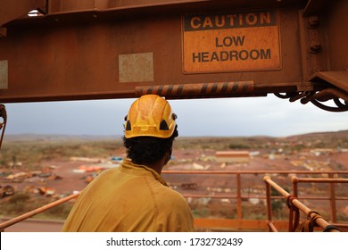 Safety Workplace Caution Sign Low Headroom Attached On Beam Structure With Construction Worker Wearing A Yellow Safety Hard Hat While Walking Underneath 