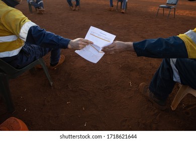 Safety Workplace Construction Worker Setting On The Chair Maintains 1.5 Metre Social Distancing Prevention Of Coronavirus -19 During Prestating, And Hand Over Paperwork To Signing Off Risk Assessment 