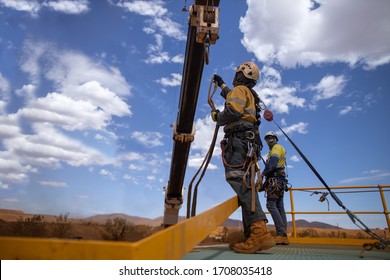 Safety Workplace Defocused  An Inertia Reel Shock Absorbing Hook Fall Arrest Device Clipping On The Back Rigger Safety Harness Hook While Working At Heights Crane Lifting From Exposure Open Edges 