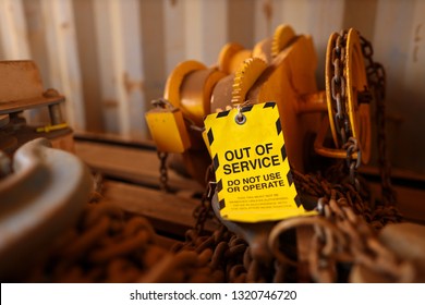 Safety Workplaces Yellow Out Of Service Tag Attached On Faulty Damage Defect Of Heavy Duty Lifting Beam Trolley At Construction Mine Site Perth, Australia