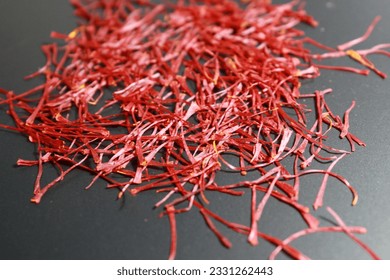 Saffron , the most expensive spice in the world, derived from the dried stigmas from the flower of saffron crocus. These stigmas are used to make saffron spice, food coloring and medicines . - Shutterstock ID 2331262443