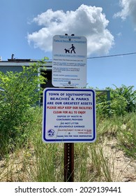 Sag Harbor, NY, USA, 7.24.21 - Signs Posted From The Town Of Southampton Listing The Rules And Regulations Of Foster Memorial Beach. Behind The Informational Post Is A Public Restroom And Showers.