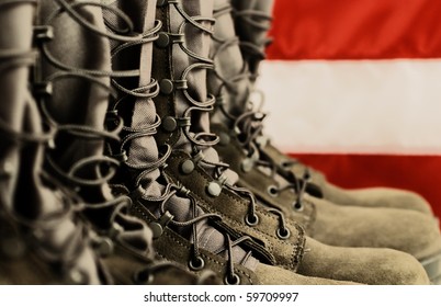 Sage green military combat boots with US flag in the background.