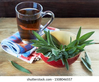 Sage herbal tea or decoction in  two glass cups with herb leaves all around on linen blue with red napkin and wooden table, closeup, copy space, alternative medicine and naturopathy concept - Shutterstock ID 1508046557