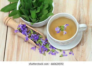 Sage Herbal Tea, Salvia Officinalis,  With Sage Leaves And Flowers On Wooden Board