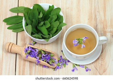 Sage Herbal Tea, Salvia Officinalis,  With Sage Leaves And Flowers On Wooden Board