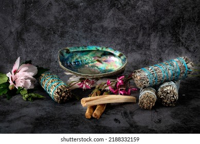 Sage, Palo Santo And Abalone In Front Of Gray Background