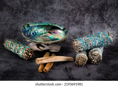 Sage, Palo Santo And Abalone In Front Of Gray Background