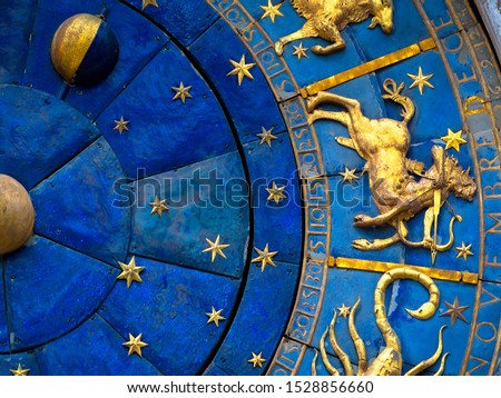 Sagittarius astrological sign on old clock in Venice, Italy. Detail of Zodiac wheel with Sagittarius. Golden symbol of Sagittarius on star circle closeup. Concept of horoscope, vintage mechanism.