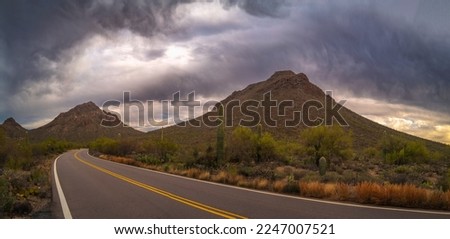 Saguaro National Park Hiking Trail Landscape Series, Tucson Mountain Gates Pass Scenic Lookout panorama with dramatic stormy clouds at sunset in Tucson, Arizona, USA