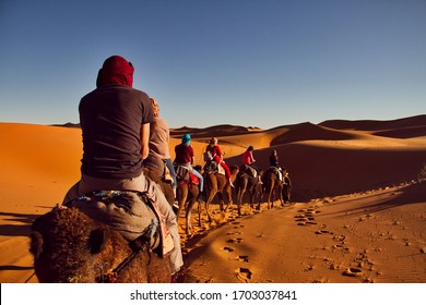 Sahara Desert, Morocco, December, 2019.: People Riding Camels In Sahara