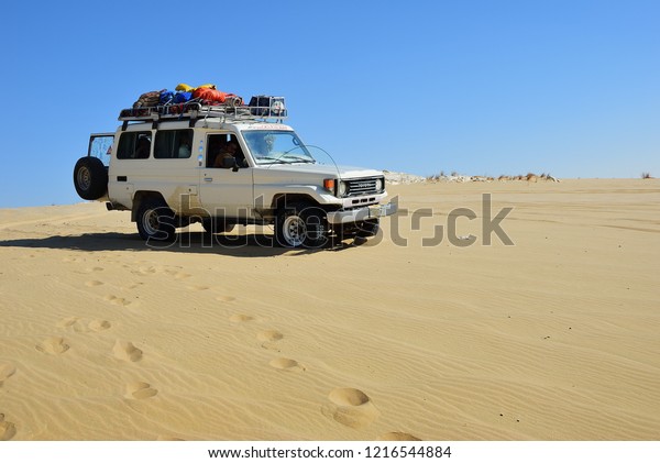 Sahara, Egypt - December 27, 2008: Off-road car\
shown in the White desert. Extreme desert safari is one of the main\
local tourist attraction in\
Egypt