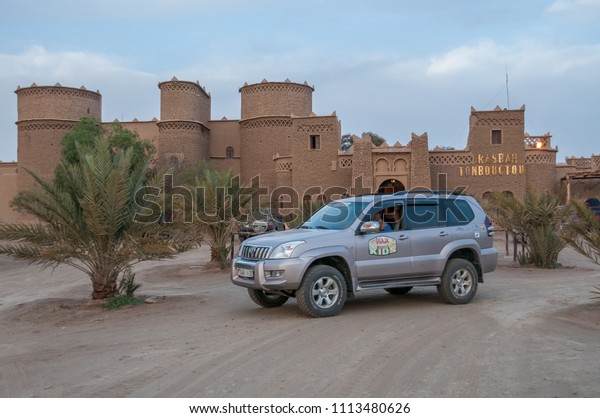Sahara,\
Morocco - march 22, 2012: All-terrain vehicle parked at the door of\
a Kasbah hotel in the Erg Chebbi desert at\
dusk