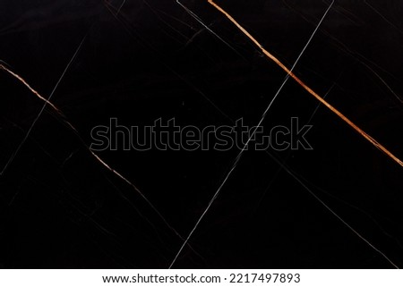 Sahara Noir Marble background, dark texture as part of your office design. Slab photo. Soft Italian stone texture for interior, exterior home decoration, floor tiles and ceramic wall tiles surface.
