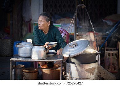 Saigon, Vietnam - June 2017: elderly woman selling coffee on street market, Saigon, Vietnam.
