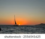 Sail boat in Pacific Ocean at sunset