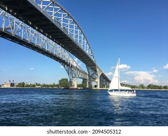 Sail Boat Passing Under The Blue Water Bridge In Port Huron, Michigan.