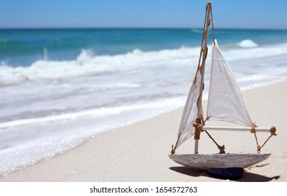 Sail Boat Toy On Sandy Beach