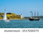 Sail ship, sailboats and Georges Island’s lighthouse, Nova Scotia