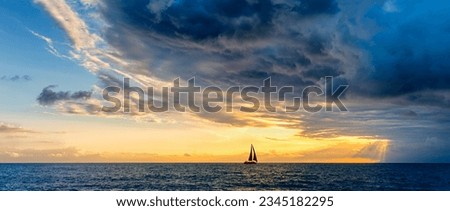 A Sailboat Approaching Sun Rays With A Storm Looming Overhead Banner