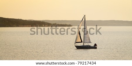 A sailboat basked in golden light on Lewis and Clark Lake in South Dakota.
