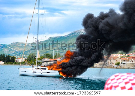 Sailboat caught on fire in a Marina with turquoise water