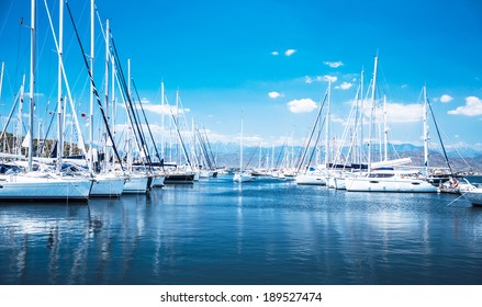 Sailboat harbor, many beautiful moored sail yachts in the sea port, modern water transport, summertime vacation, luxury lifestyle and wealth concept