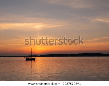 Sailboat near harbour of West Frisian island Vlieland at sunset, Waddensea