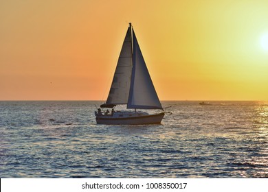 Sailboat Sailing Into The Sunset.