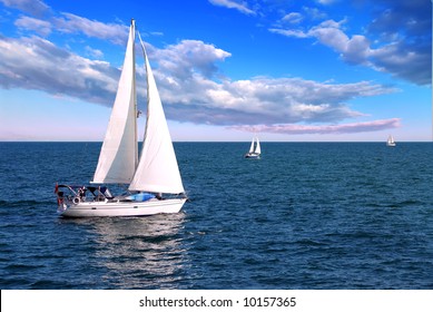 Sailboat sailing in the morning with blue cloudy sky - Powered by Shutterstock