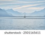 Sailboat sailing on Lake Geneva. Sunny Lac Léman landscape. Lake Geneva. Sunny Swiss Vevey Mountain and Water Background View